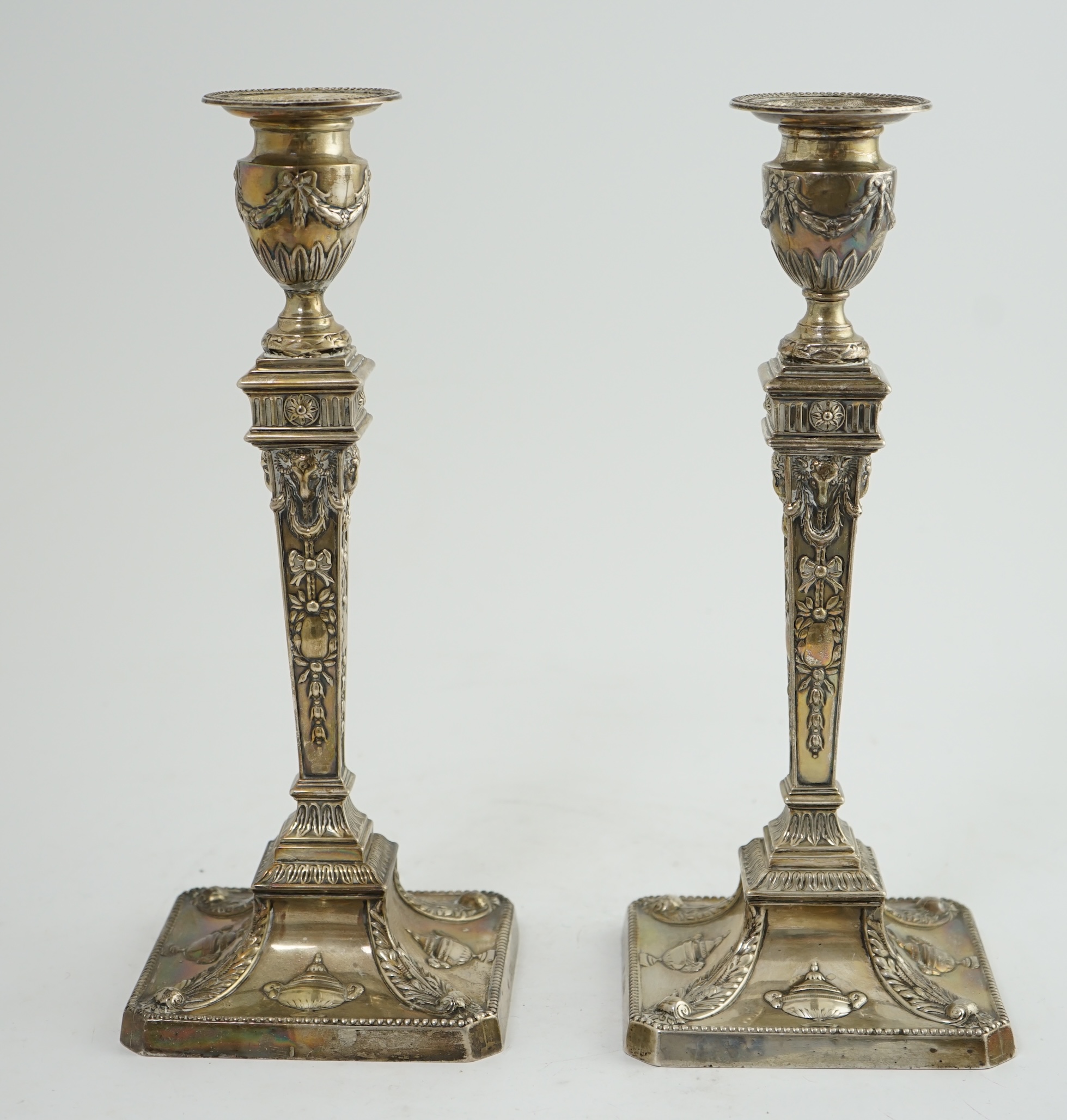 A pair of late Victorian silver Adam style candlesticks, by William Hutton & Sons, (a.f.)